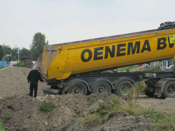 De Oenema-chauffeur heeft zijn bak geleegd. Hij verwijdert de laatste zandresten, hij heeft hart voor zijn vrachtwagen!